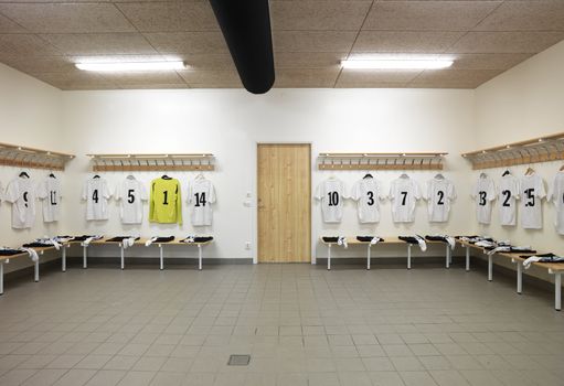 Soccer teams dressing room with numbered shirts