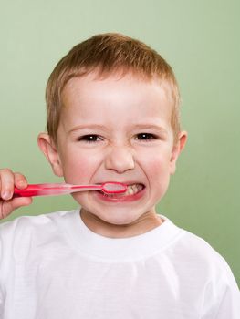 Little child with dental toothbrush brushing teeth