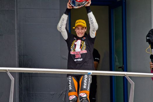 JEREZ DE LA FRONTERA, SPAIN - NOV 20: 125cc motorcyclist Alex Rins on the podium like winner of the 125cc CEV Championship on November 20, 2011, in Jerez de la Frontera, Spain