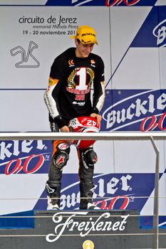 JEREZ DE LA FRONTERA, SPAIN - NOV 20: 125cc motorcyclist Alex Rins on the podium like winner of the 125cc CEV Championship on November 20, 2011, in Jerez de la Frontera, Spain