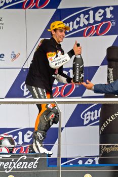 JEREZ DE LA FRONTERA, SPAIN-NOV 20: 125cc motorcyclist Alex Rins on the podium like winner of the 125cc CEV Championship celebrating with champagne on November 20, 2011, in Jerez de la Frontera, Spain