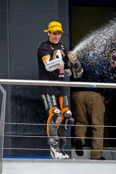 JEREZ DE LA FRONTERA, SPAIN-NOV 20: 125cc motorcyclist Alex Rins on the podium like winner of the 125cc CEV Championship celebrating with champagne on November 20, 2011, in Jerez de la Frontera, Spain