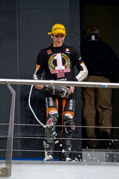 JEREZ DE LA FRONTERA, SPAIN-NOV 20: 125cc motorcyclist Alex Rins on the podium like winner of the 125cc CEV Championship celebrating with champagne on November 20, 2011, in Jerez de la Frontera, Spain