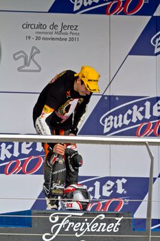 JEREZ DE LA FRONTERA, SPAIN - NOV 20: 125cc motorcyclist Alex Rins on the podium like winner of the 125cc CEV Championship on November 20, 2011, in Jerez de la Frontera, Spain