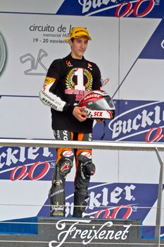 JEREZ DE LA FRONTERA, SPAIN - NOV 20: 125cc motorcyclist Alex Rins on the podium like winner of the 125cc CEV Championship on November 20, 2011, in Jerez de la Frontera, Spain