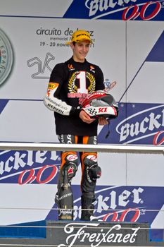 JEREZ DE LA FRONTERA, SPAIN - NOV 20: 125cc motorcyclist Alex Rins on the podium like winner of the 125cc CEV Championship on November 20, 2011, in Jerez de la Frontera, Spain