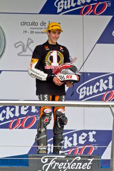 JEREZ DE LA FRONTERA, SPAIN - NOV 20: 125cc motorcyclist Alex Rins on the podium like winner of the 125cc CEV Championship on November 20, 2011, in Jerez de la Frontera, Spain