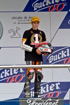 JEREZ DE LA FRONTERA, SPAIN - NOV 20: 125cc motorcyclist Alex Rins on the podium like winner of the 125cc CEV Championship on November 20, 2011, in Jerez de la Frontera, Spain