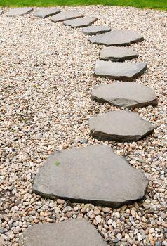 Path from stone with green herb