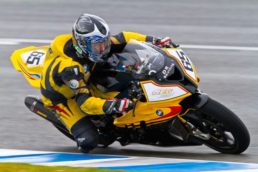 JEREZ DE LA FRONTERA, SPAIN - NOV 20: Stock Extreme motorcyclist Juan Eric Gomez takes a curve in the CEV Championship race on November 20, 2011 in Jerez de la Frontera, Spain