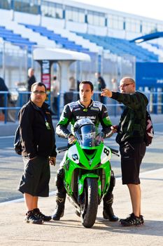 JEREZ DE LA FRONTERA, SPAIN - APR 16: Kawasaki Ninja Cup motorcyclist Adria Araujo speaks with the engineers in the CEV Championship race on April 16, 2011 in Jerez de la Frontera, Spain.