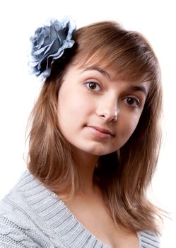 Portrait of the young girl in flower in hair on white background