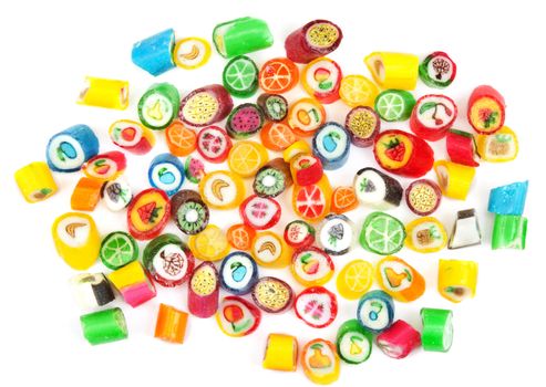Varicoloured sweet lollipop is spilt on white background