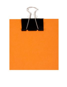 Orange note and black staple on white background
