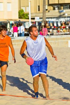 CADIZ, SPAIN - JULY 19: Unidentified players compete in a match between Los Negritos and Autoescuela Barquin in the 19th league of beach handball of Cadiz on July 19, 2011 in Cadiz, Spain