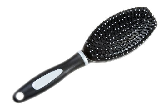 Black massage plastic comb on white background