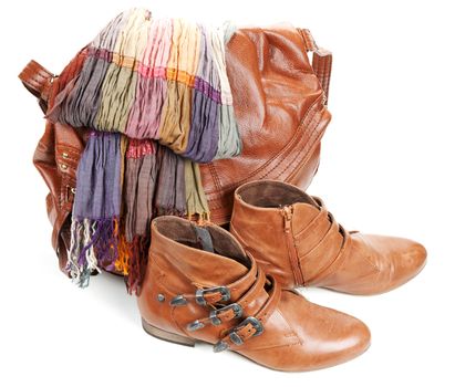 Brown leather bag, scarf and pair feminine boots on white background