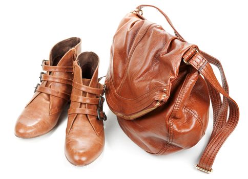 Brown leather bag and pair feminine boots on white background