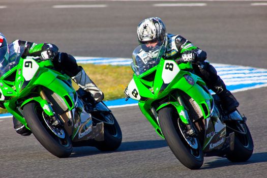 JEREZ DE LA FRONTERA, SPAIN - APR 16: Kawasaki Ninja Cup motorcyclist Adria Araujo(8) and David Cruz(9) takes a curve in the CEV Championship race on April 16, 2011 in Jerez de la Frontera, Spain.