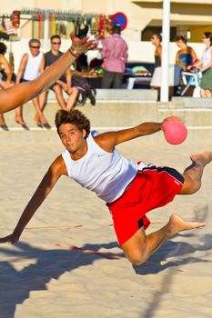 CADIZ, SPAIN - JULY 19: Unidentified players compete in a match between Los Negritos and Autoescuela Barquin in the 19th league of beach handball of Cadiz on July 19, 2011 in Cadiz, Spain