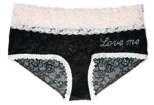 Black lacy feminine panties with inscription love me on white background