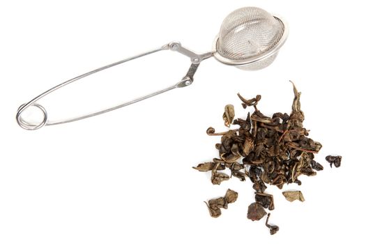 Dry green tea and strainer on white background