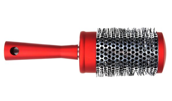 One red massages comb on white background