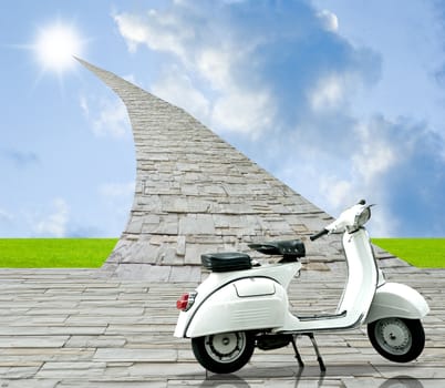 White retro scooter with stone road to sun in the sky