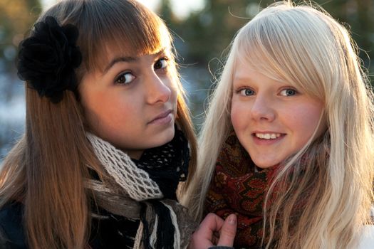 Portrait two young beautiful girls in wood