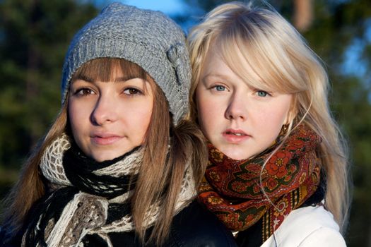 Portrait two young beautiful girls in wood