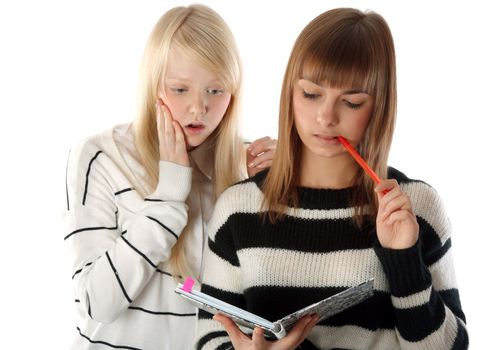 Two beautiful girls read diary book on white background
