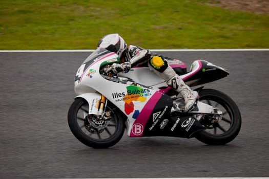 JEREZ DE LA FRONTERA, SPAIN - NOV 20: 125cc motorcyclist Miguel Poyatos Alarcon races in the CEV championship on Nov 20, 2010, in Jerez de la Frontera, Spain