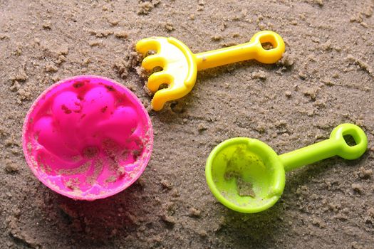 Plastic sandbox child toy on summer beach sand