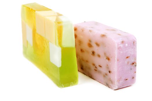 Green and purple fruit soap isolated on white background