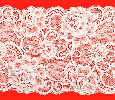 White lace with a floral pattern on a red background