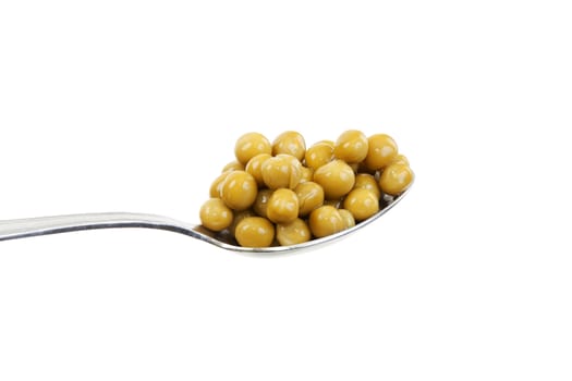 Spoon with green peas on a white background
