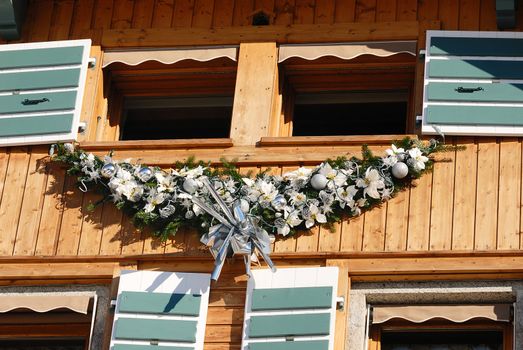 Xmas decoration ornaments on a mountain chalet windows