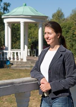 portrait of a beautiful woman with pergola at background