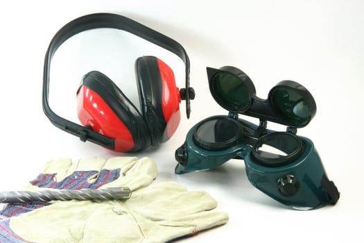 work equipment in white background drill gloves ear and eyes protection