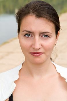 portrait of a beautiful woman with river at background