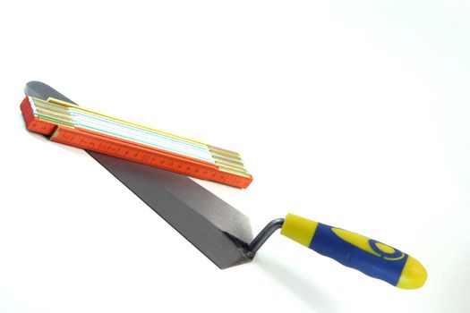 construction tools trowel and meter isolated in white background