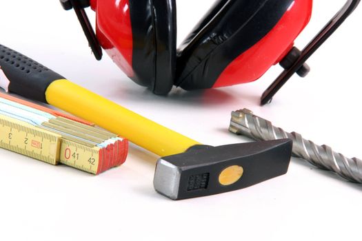hardware tools meter hamer drill and ear protection detail in white background
