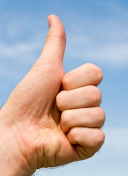 Thumbs up on a blue sky background