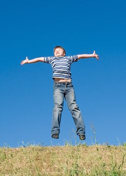 jumping boy with blue sky at background