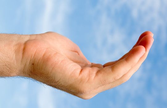 hand on a blue sky