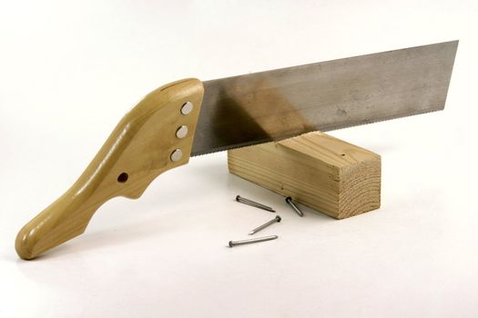 hand saw cutting wood and construction nails in white background construction concepts
