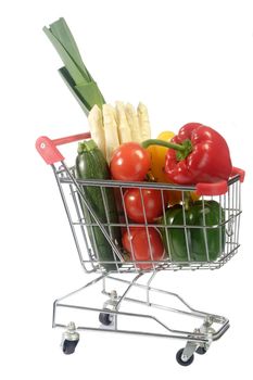Shopping trolley with fresh vegetables- isolated on white background