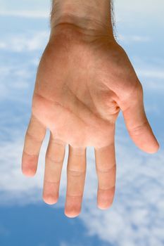 Human hand on a blue sky
