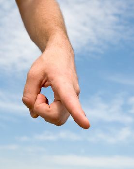 finger. Human hand on a blue sky