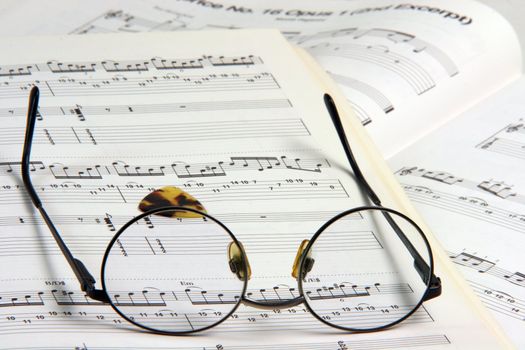 education concepts study music spectacles on a music book and guitar pick